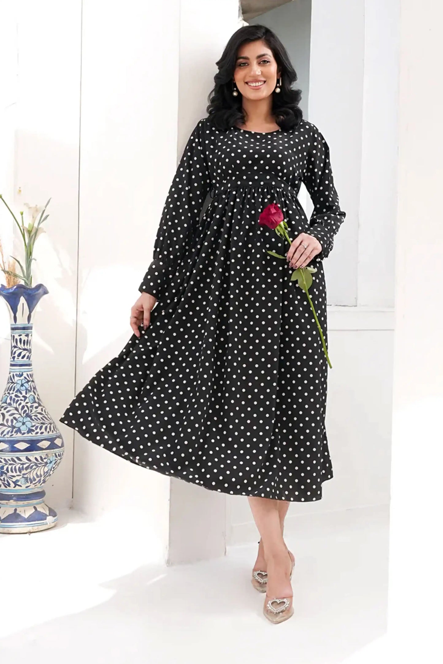 Woman wearing a black polka dot dress