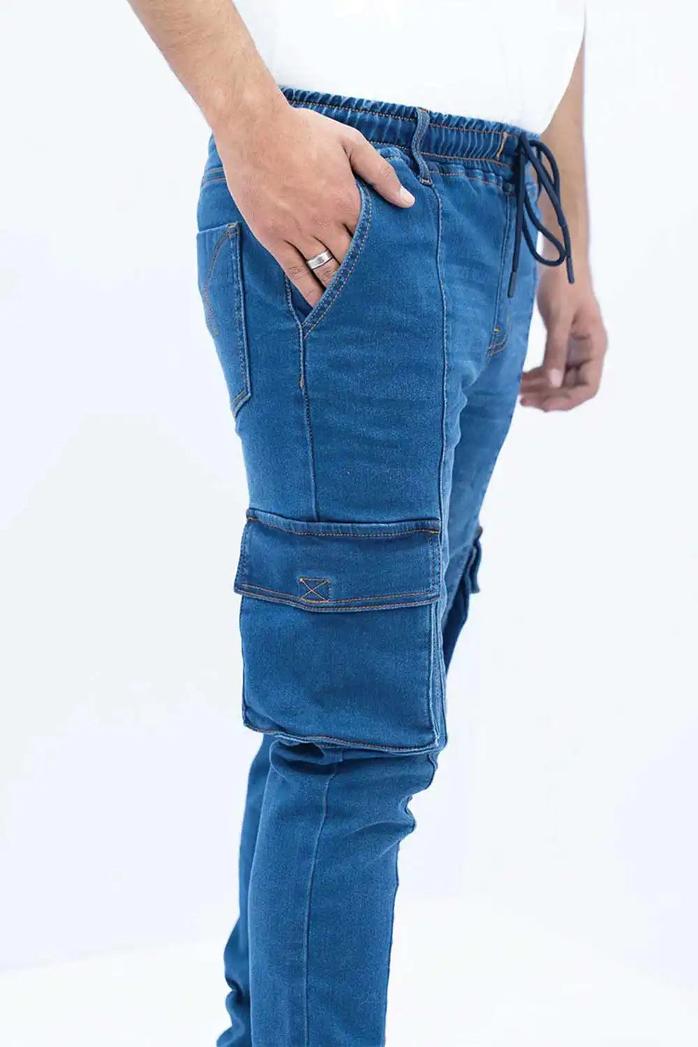 Blue cargo pants worn by a person on a white background