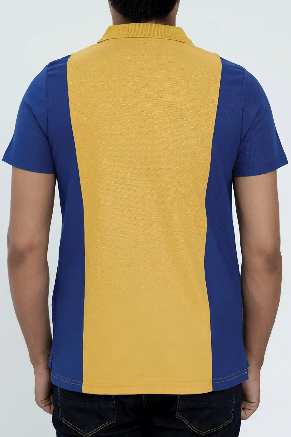 A man wearing a blue and yellow polo shirt