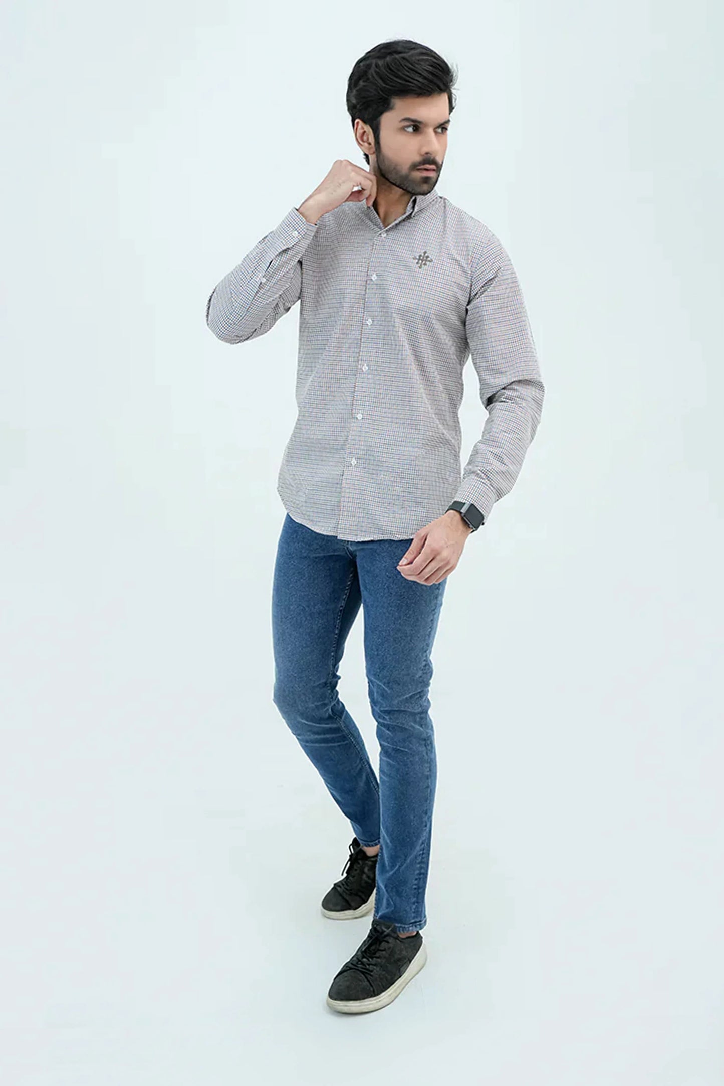 Model wearing checkered brown casual shirt with jeans