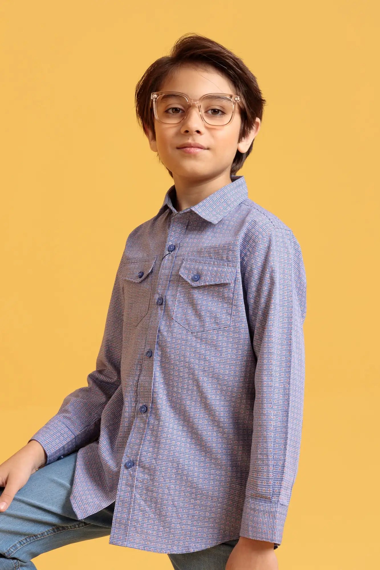 Child wearing a checkered shirt and glasses