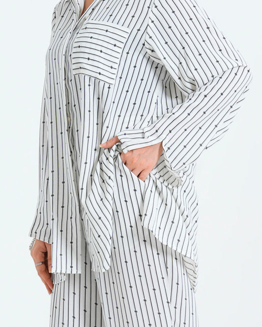 Close-up of a womenâs white co-ord set, highlighting the fabric details