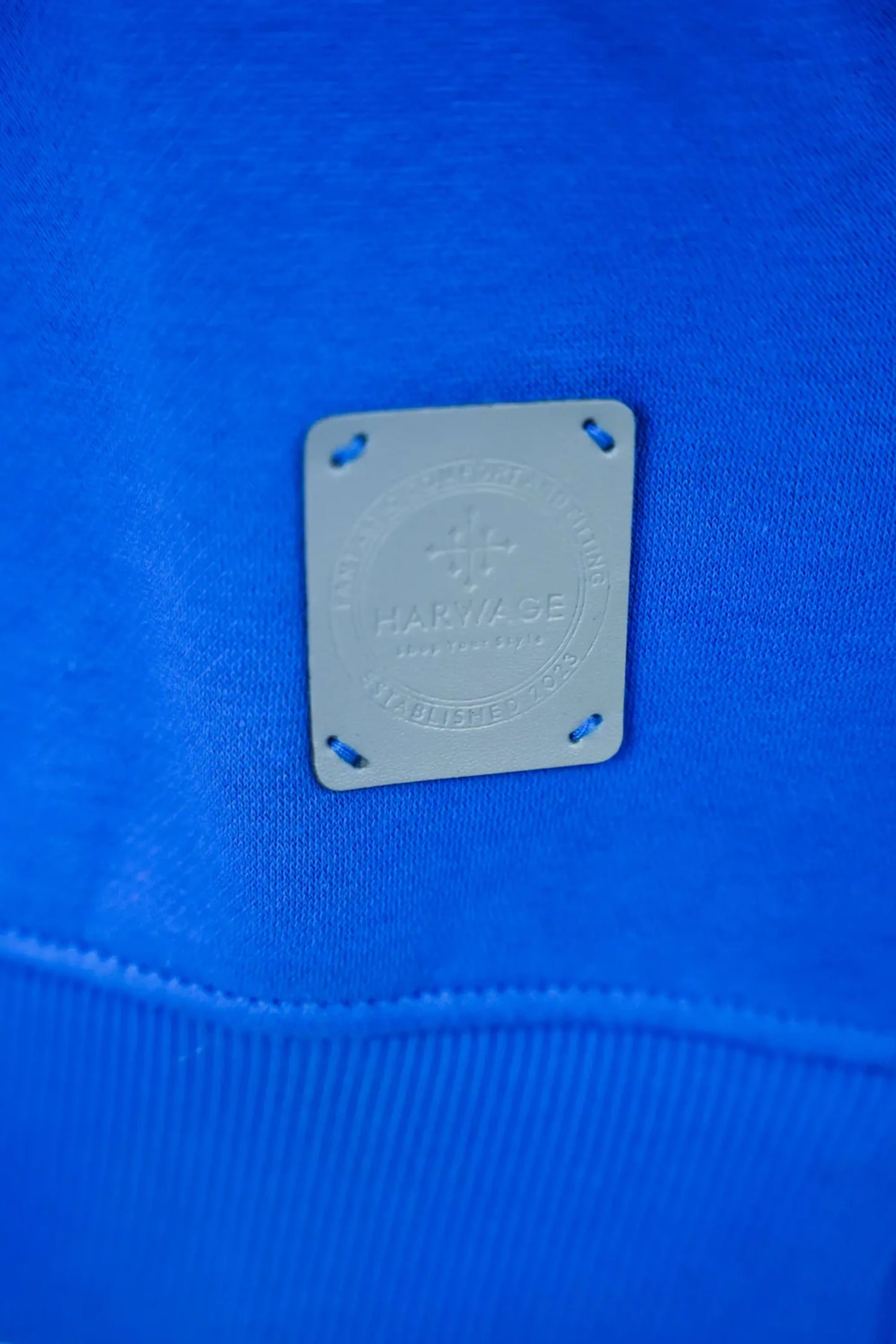 Close-up of a blue fabric with a brand label on it