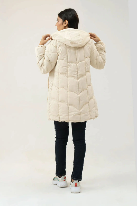 Girl wearing a beige puffer coat on a white background