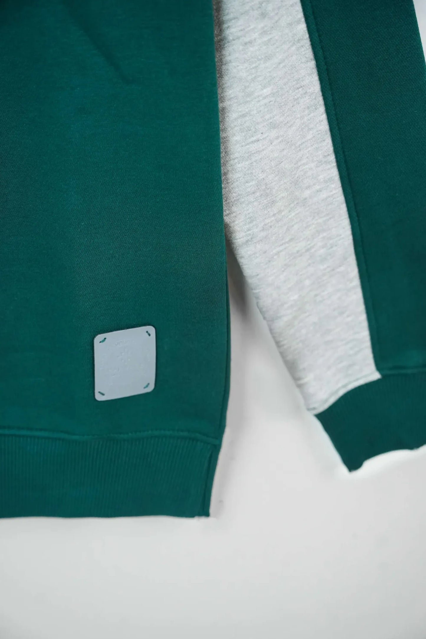 Green and gray sweatshirt with a brand logo on a white background