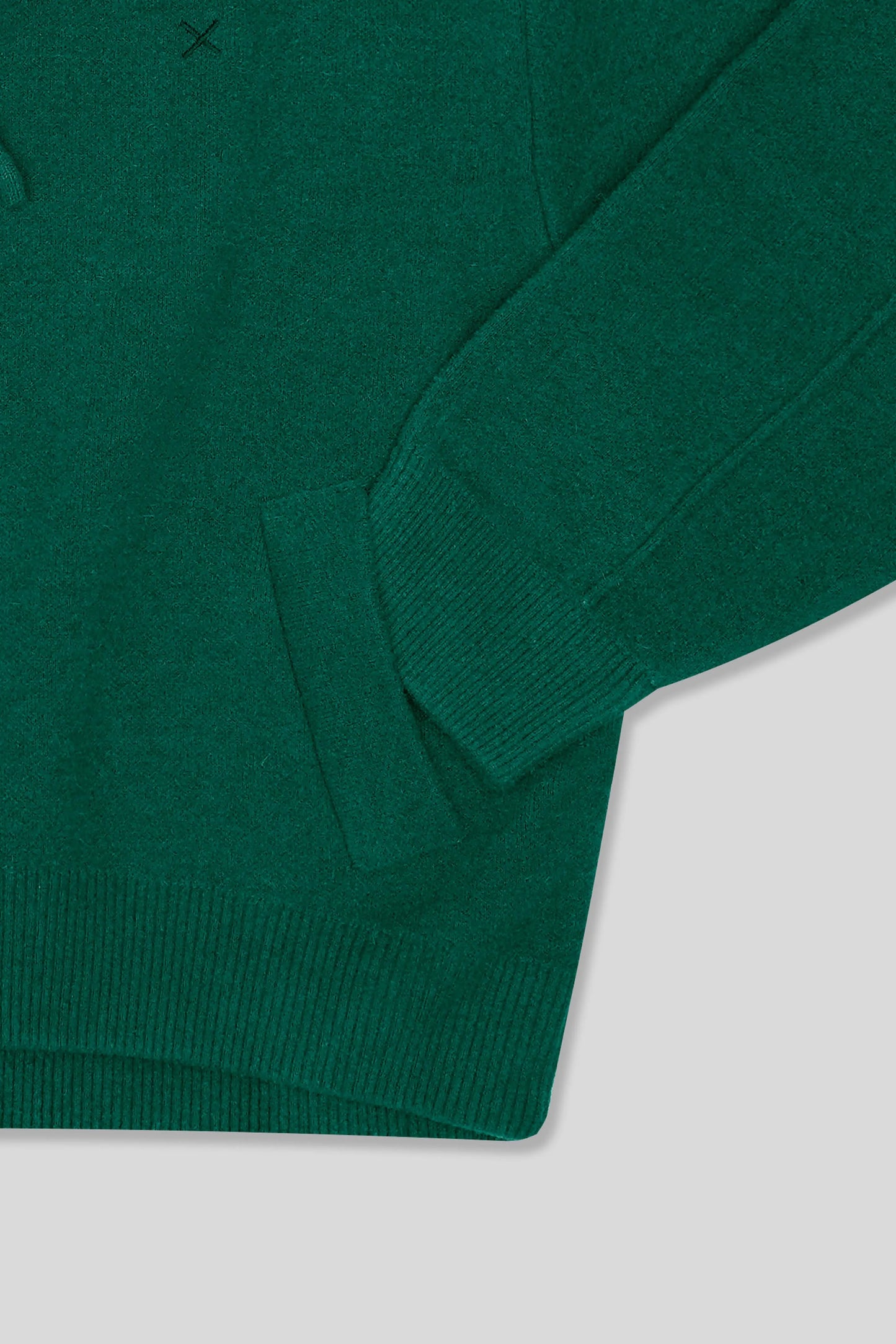 Green sweater on a light gray background