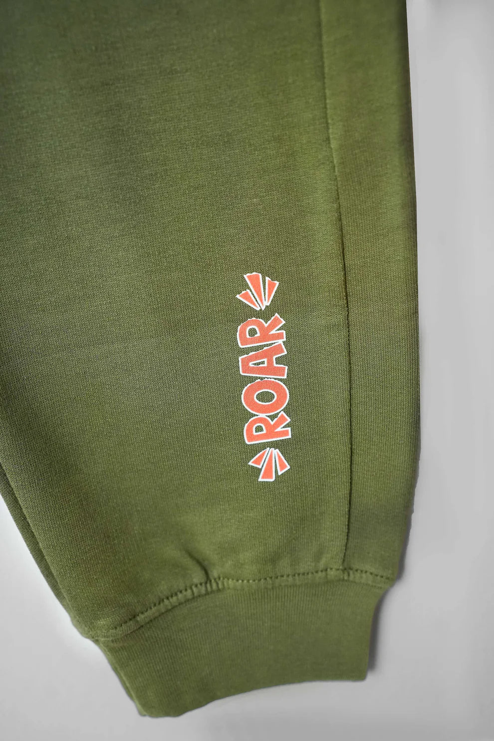 Green terry fleece trousers close up