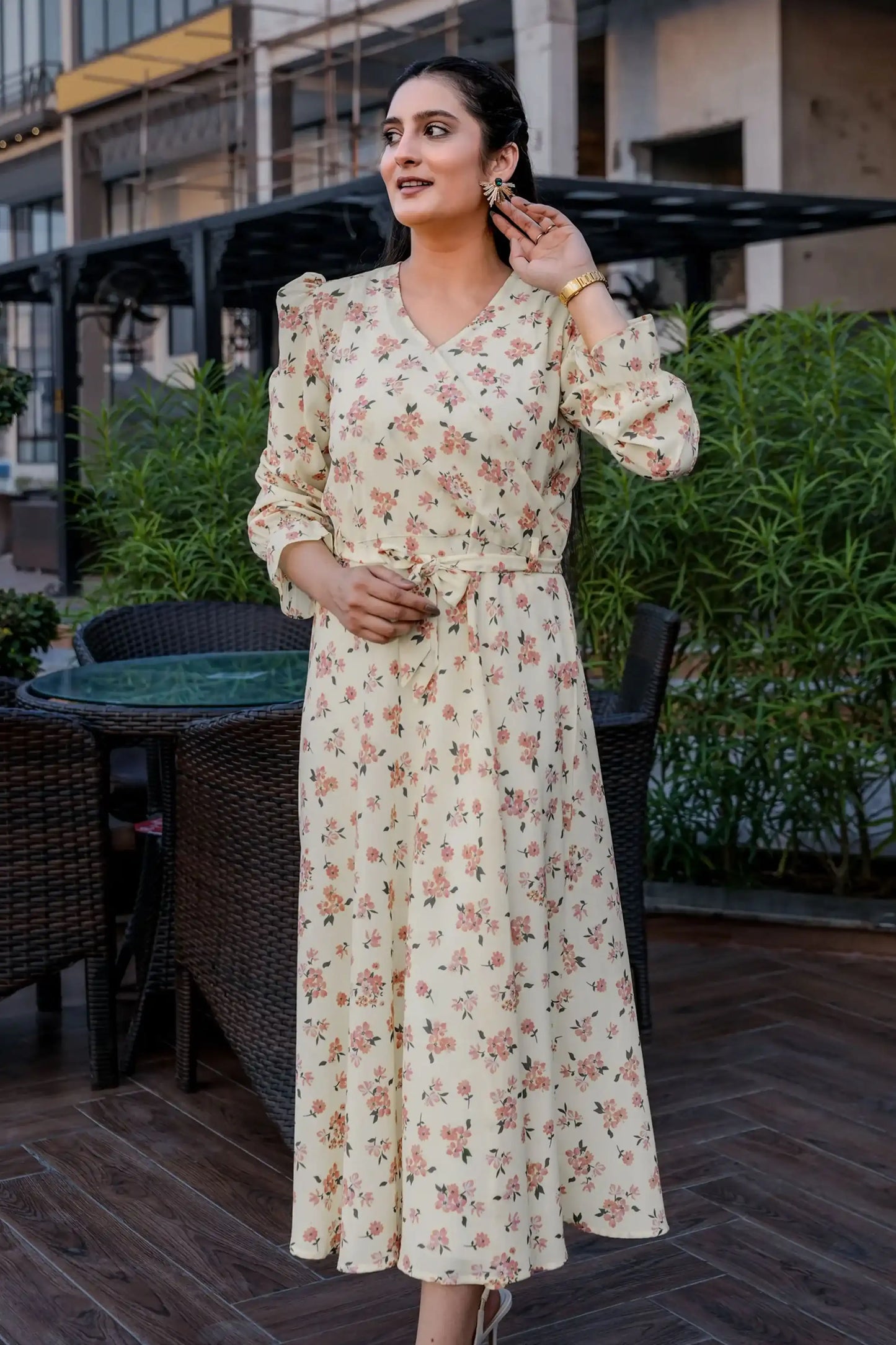 Woman in a floral dress standing outdoors