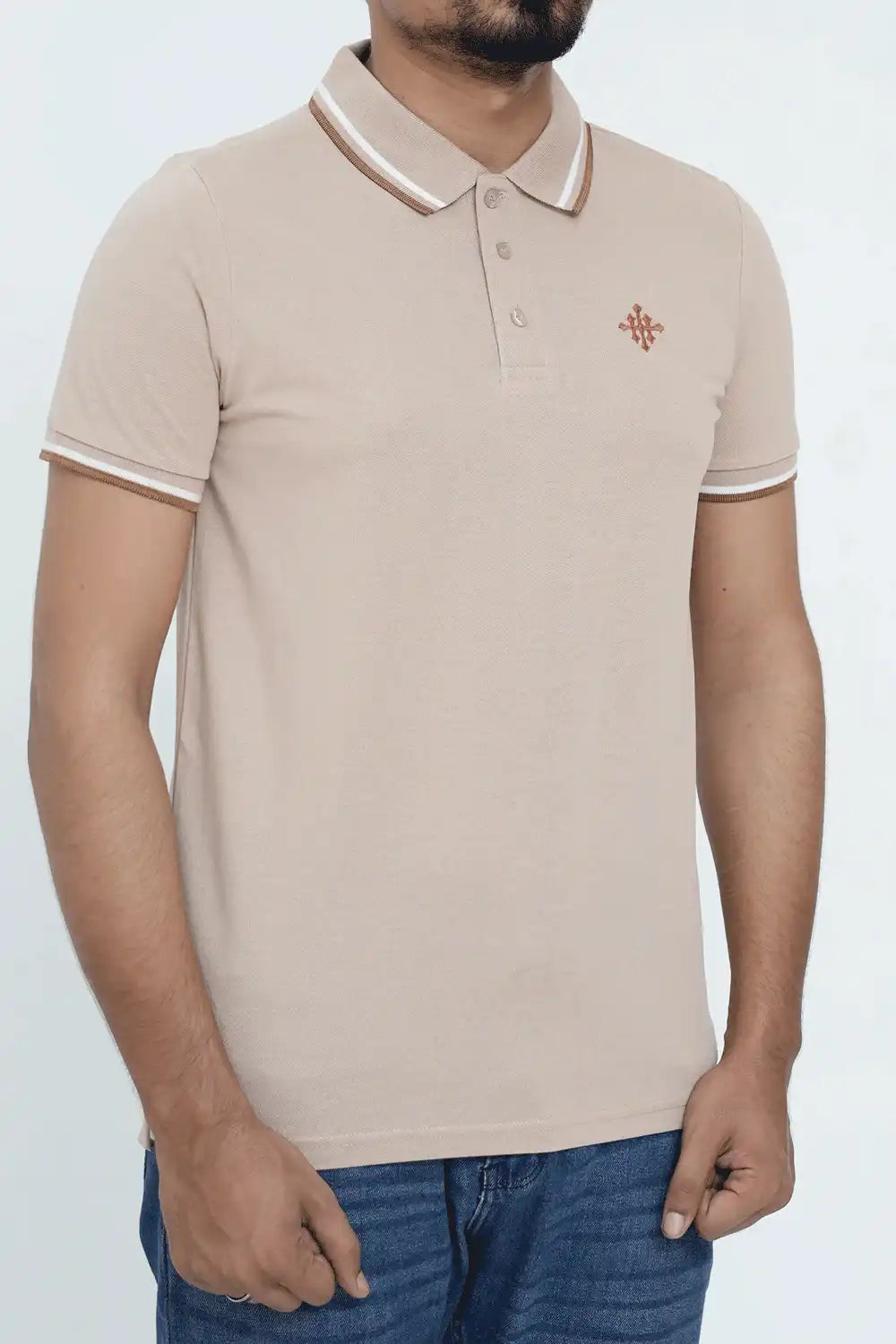 A beige polo shirt with white trim, worn by a person