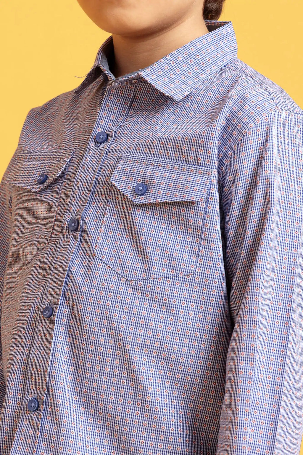 Close-up of a person wearing a blue checkered shirt 