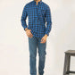 A man dressed in a blue checkered shirt and jeans