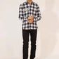 A man wearing a black and white checkered shirt and black pants