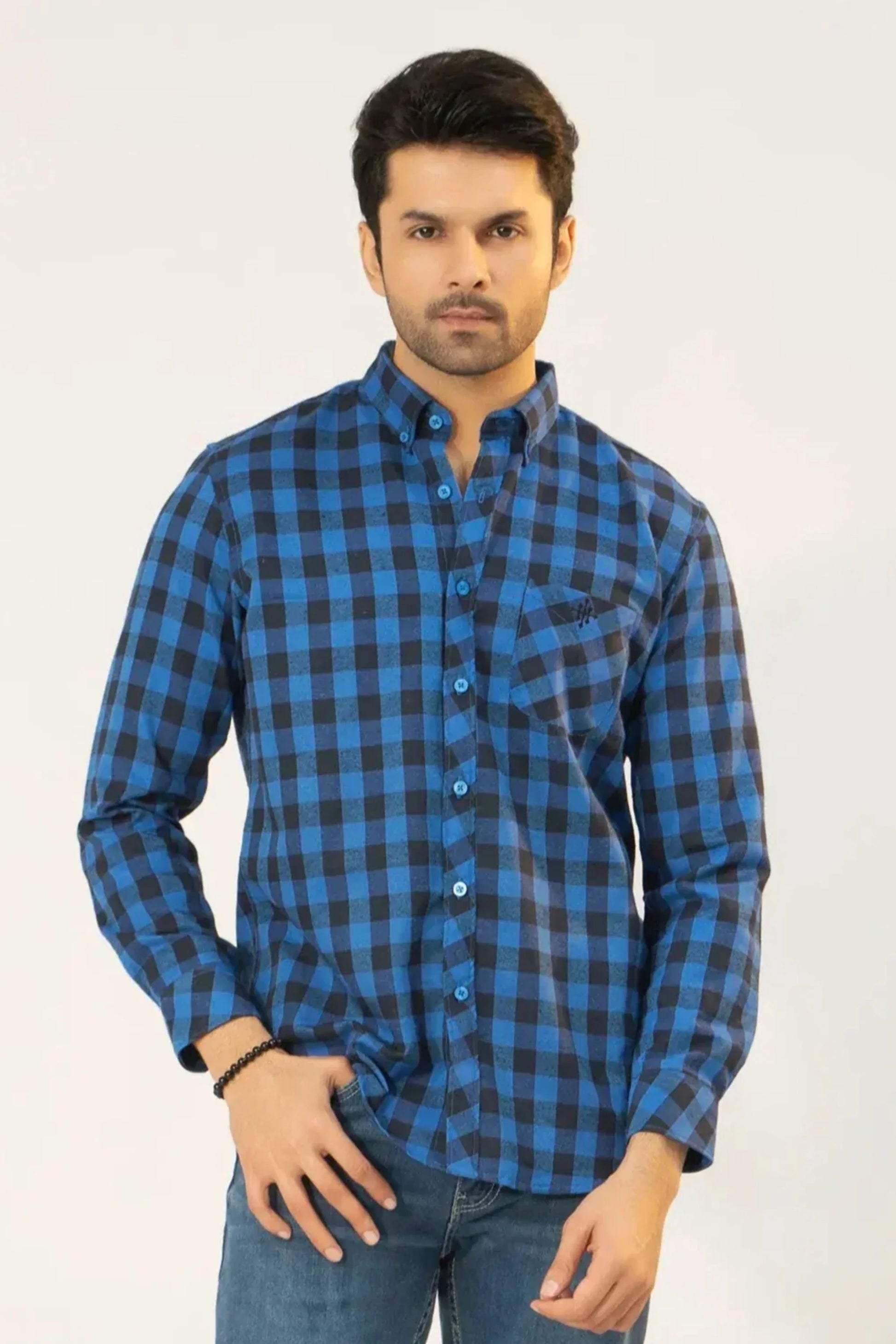 A man wearing a blue and black flannel shirt
