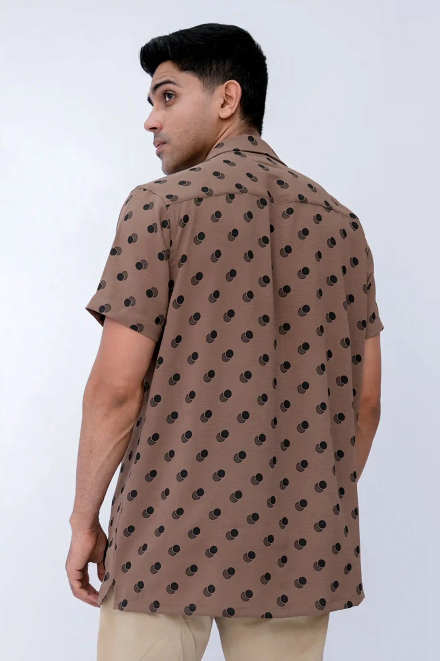 A man wearing a brown casual shirt 