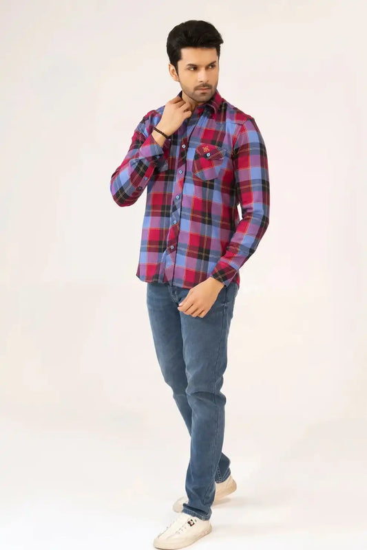 A man wearing a plaid shirt and jeans