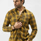 A man wearing a yellow and green plaid shirt