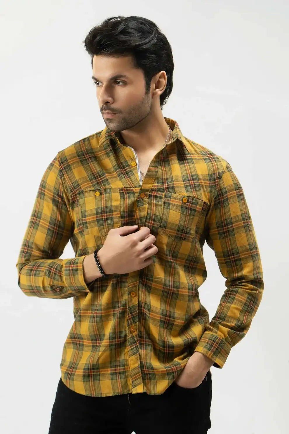 A man wearing a yellow and green plaid shirt