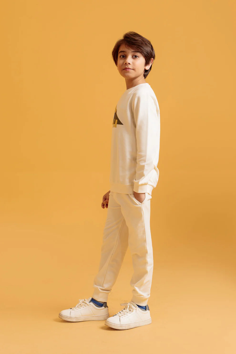 Child wearing a white sweatshirt and pants 