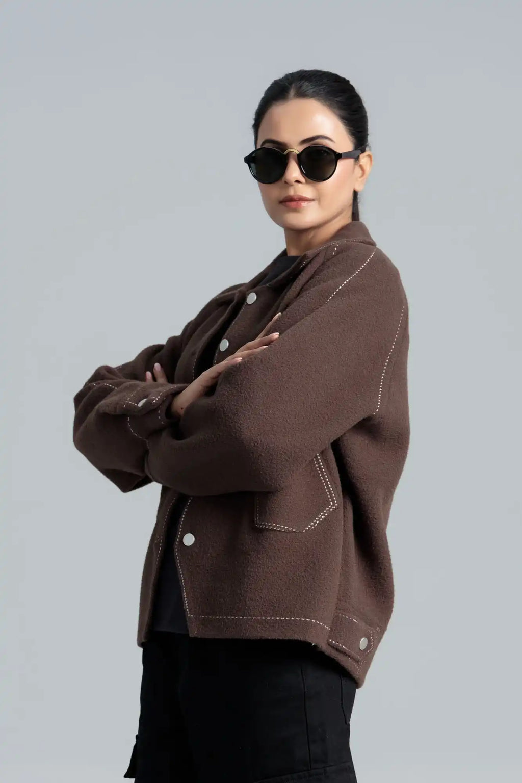 A woman wearing a Wool coat and sunglasses 