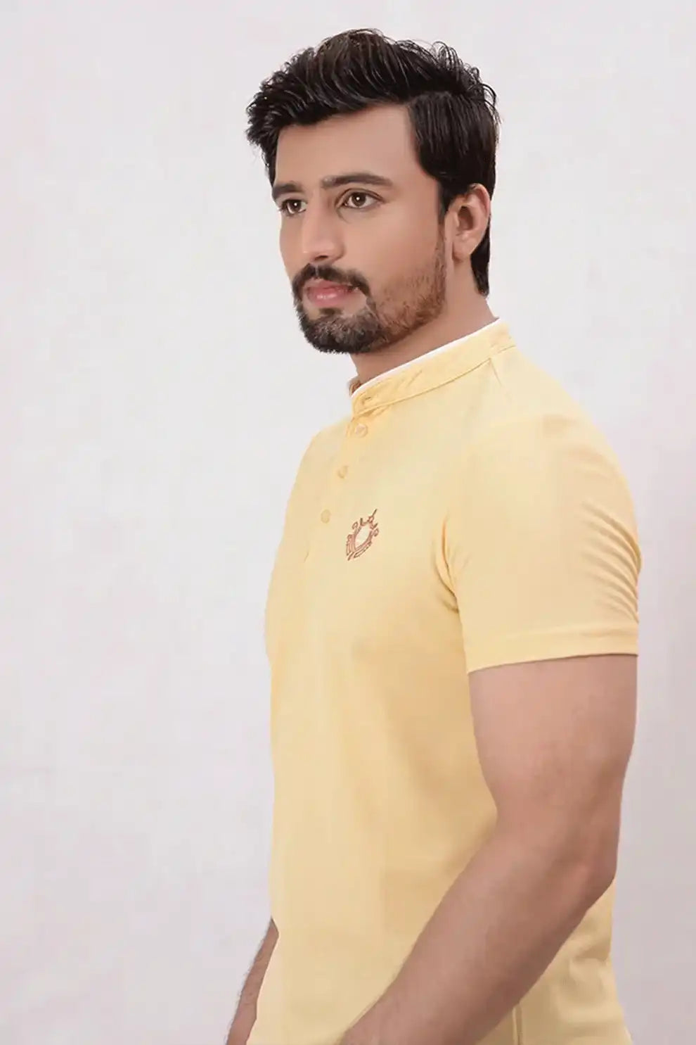 A man wearing a yellow polo shirt