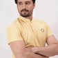 A yellow polo shirt with a brand logo