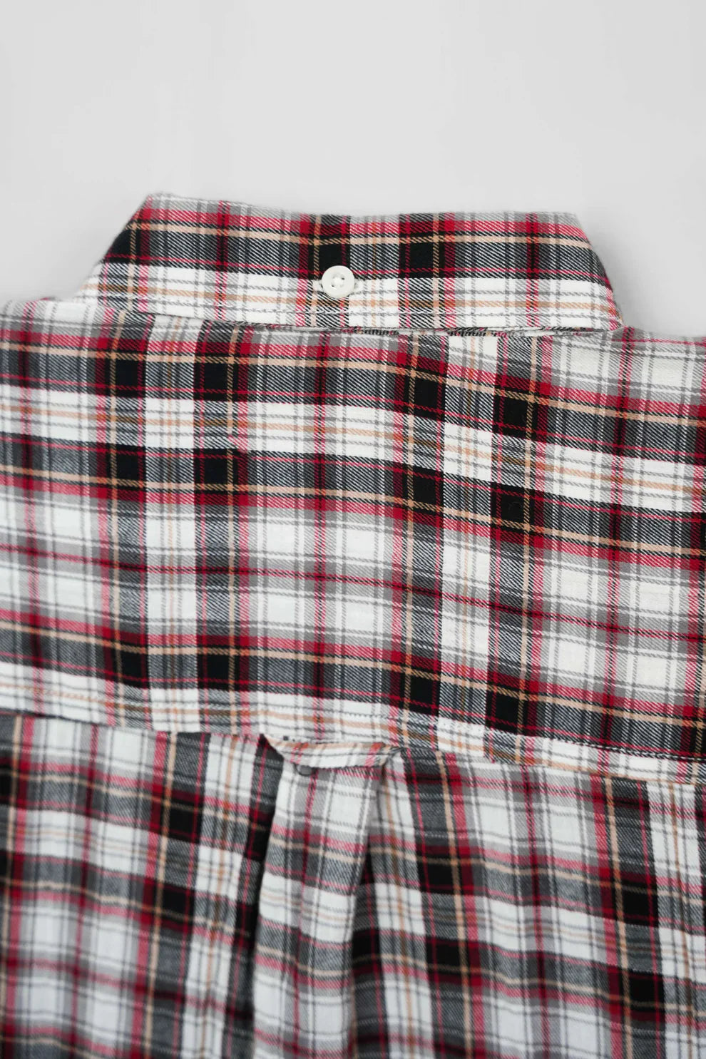 Back neck detail of plaid shirt with button