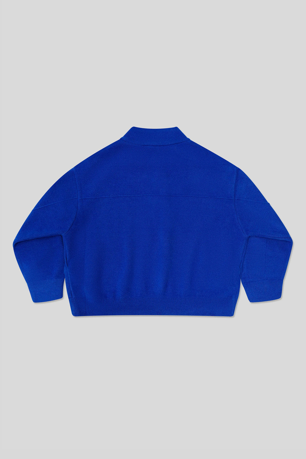Back of blue Cardigan on a light gray background