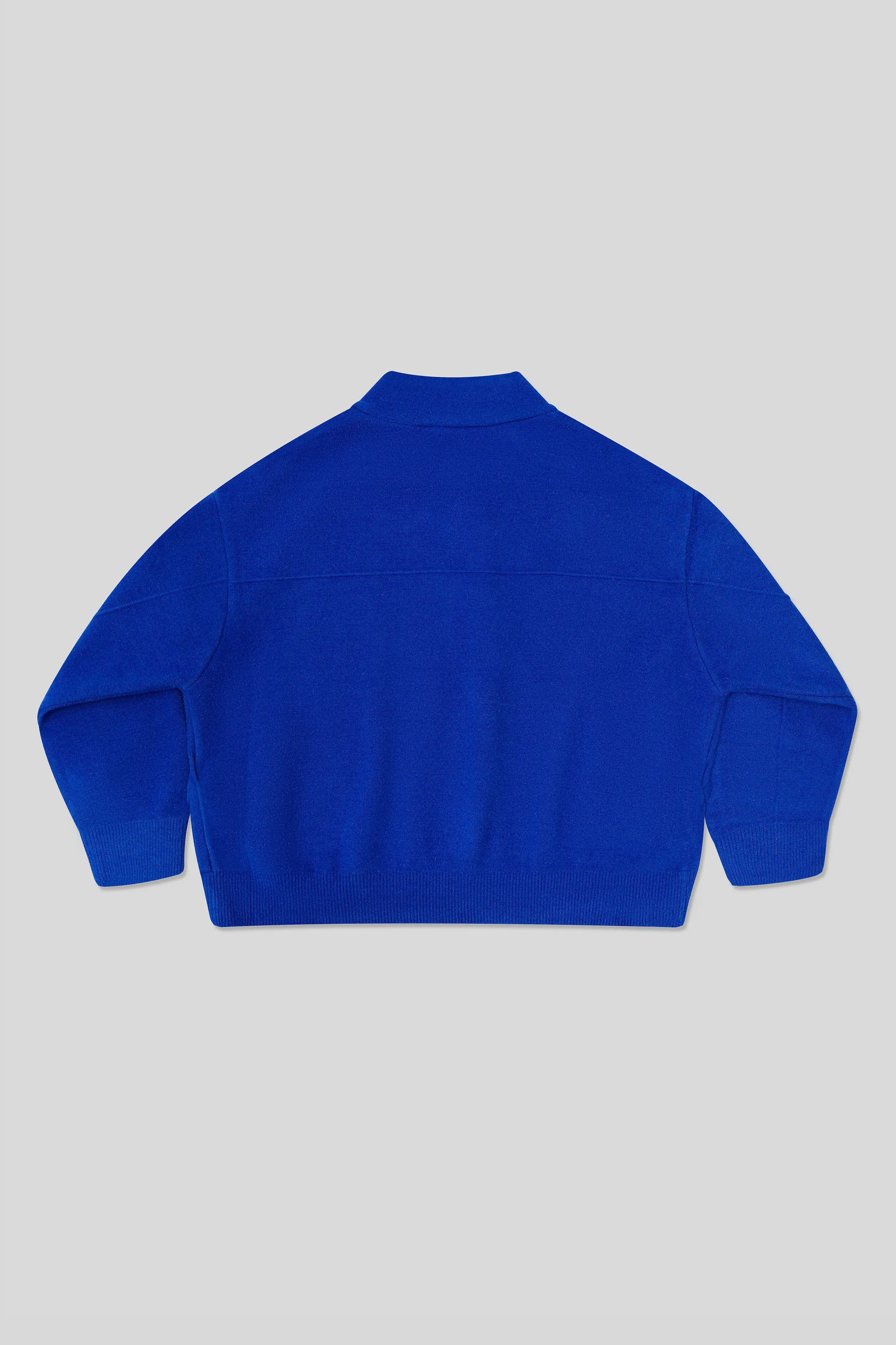 Back of blue Cardigan on a light gray background