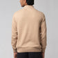 Back standing view of turtle neck sweater beige showing clean fit