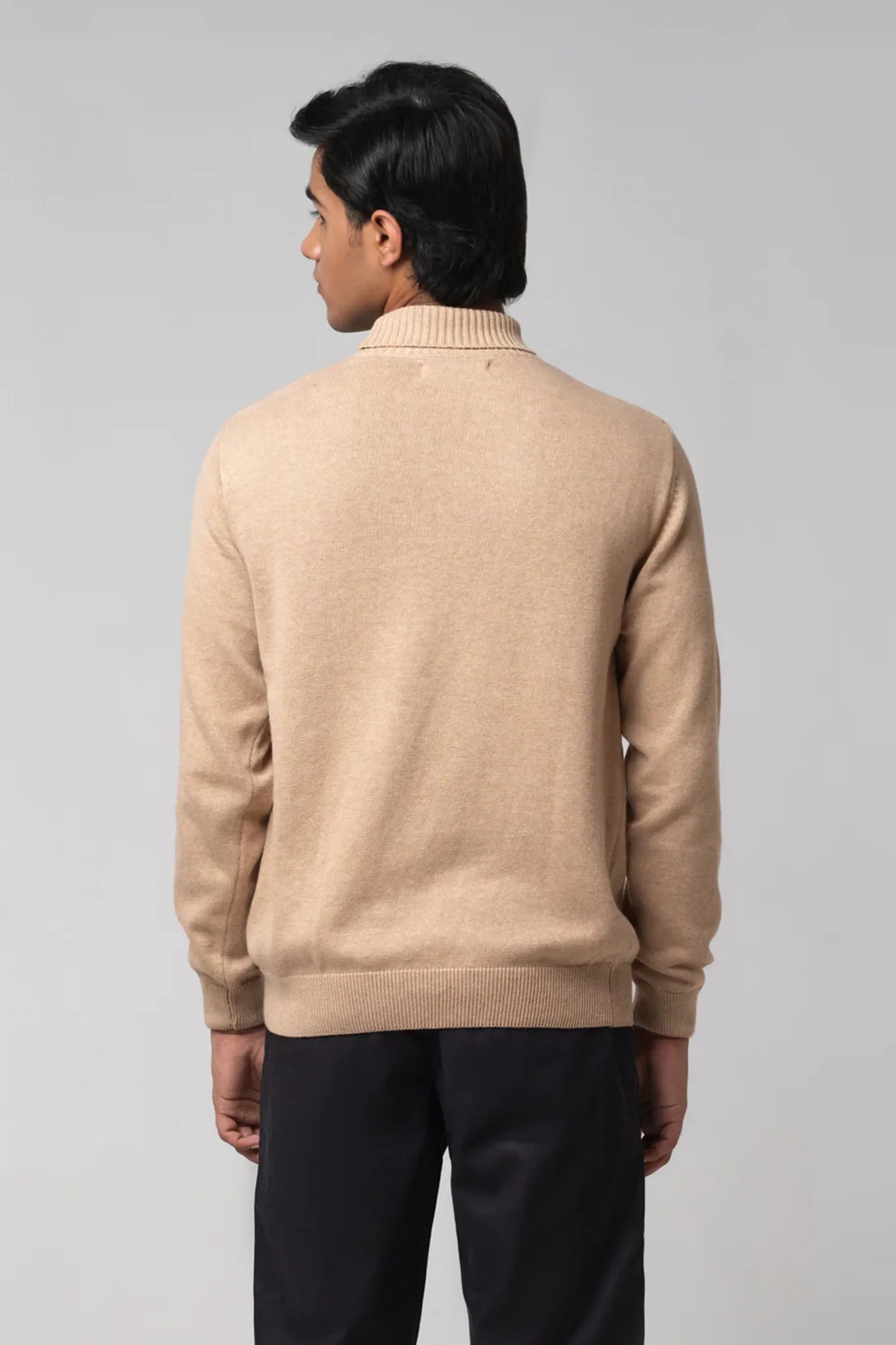 Back standing view of turtle neck sweater beige showing clean fit