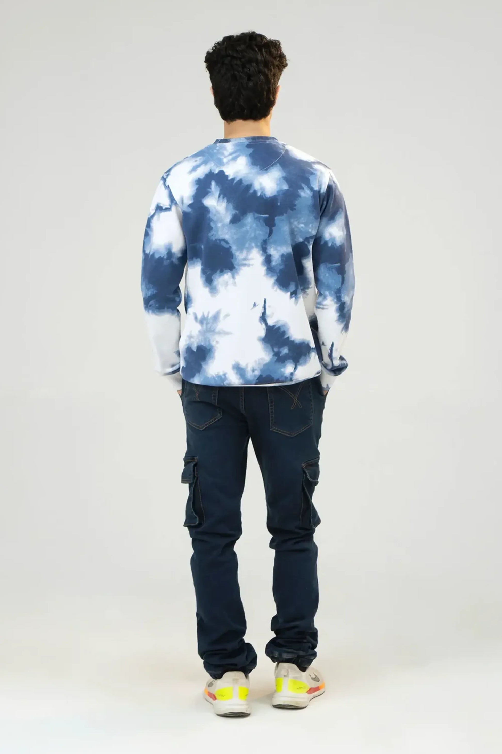 Back full-length view of Blue Tie Dye Camouflage sweatshirt with denim jeans
