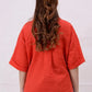 Back view of a women’s basic cropped shirt