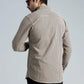 Back view of a beige and black shirt