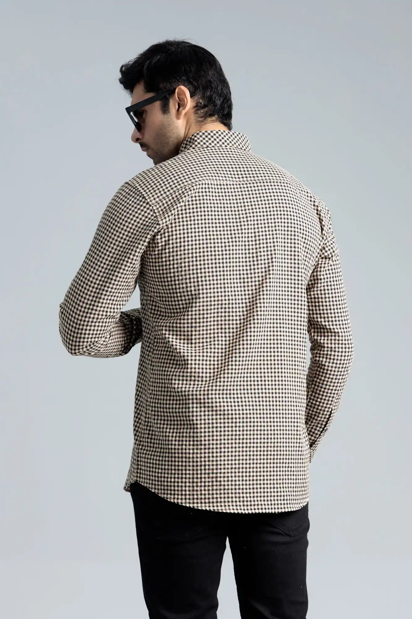 Back view of a beige and black shirt