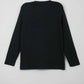 Back view of a black sweater on a light gray background