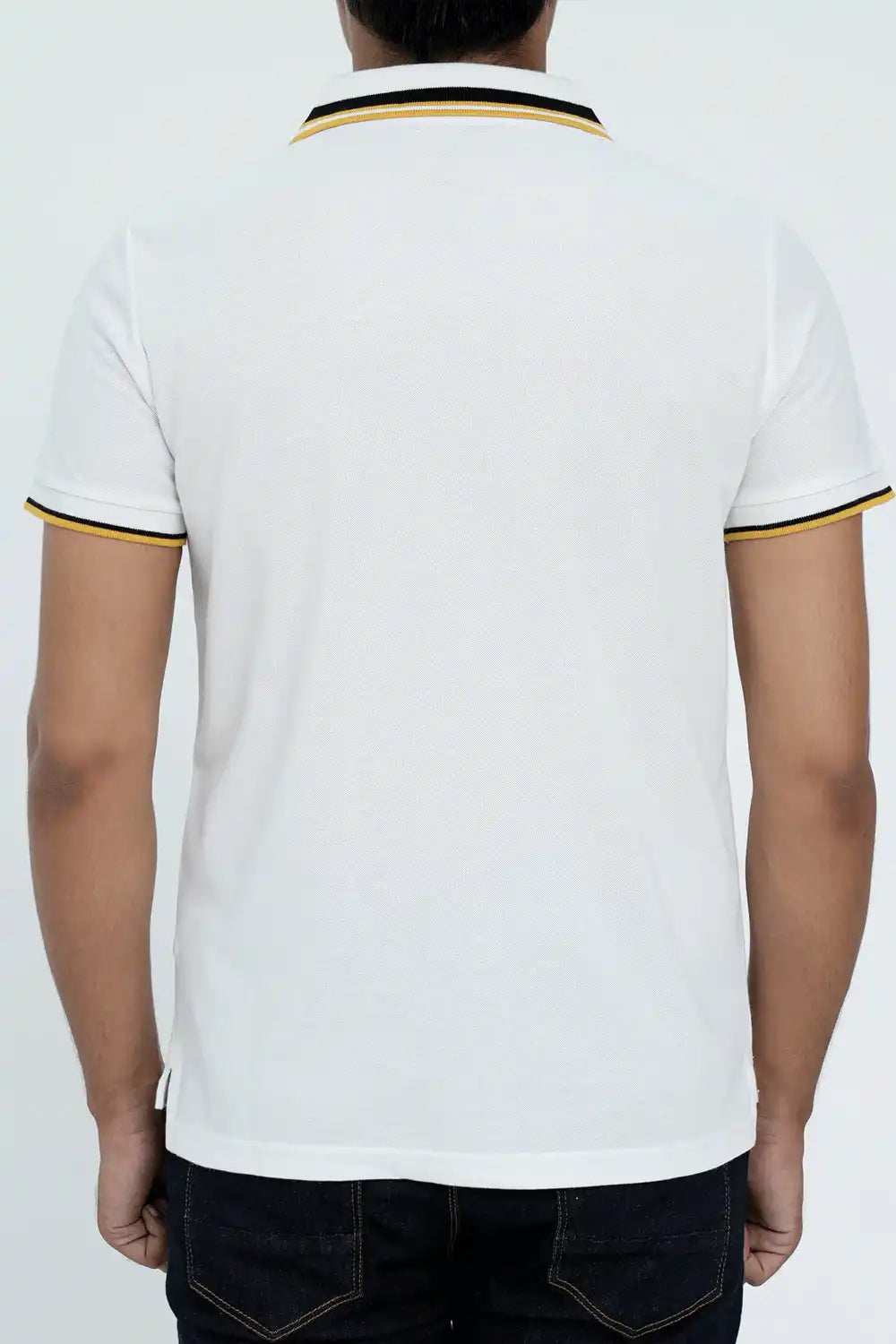Back view of a white polo shirt with black and yellow trim 
