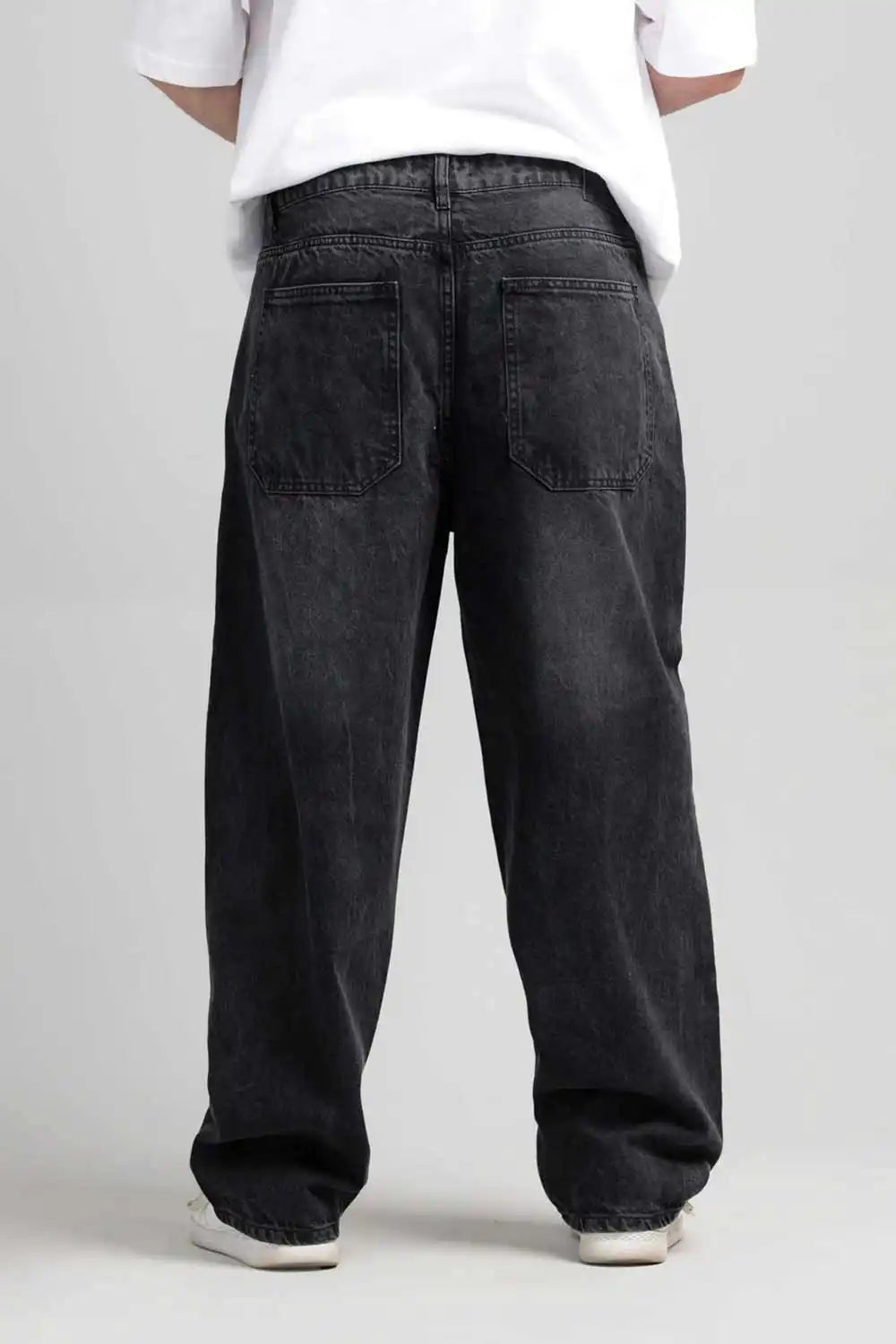 Back view of black jeans and a white shirt