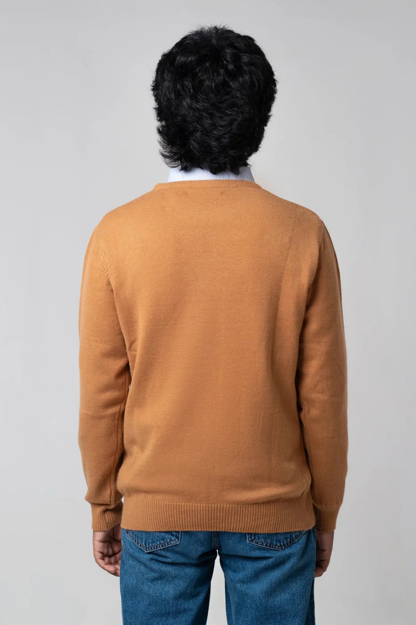 Back standing view of crew neck sweater mustard showing relaxed fit