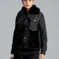 Woman wearing a black denim jacket with fur trim 