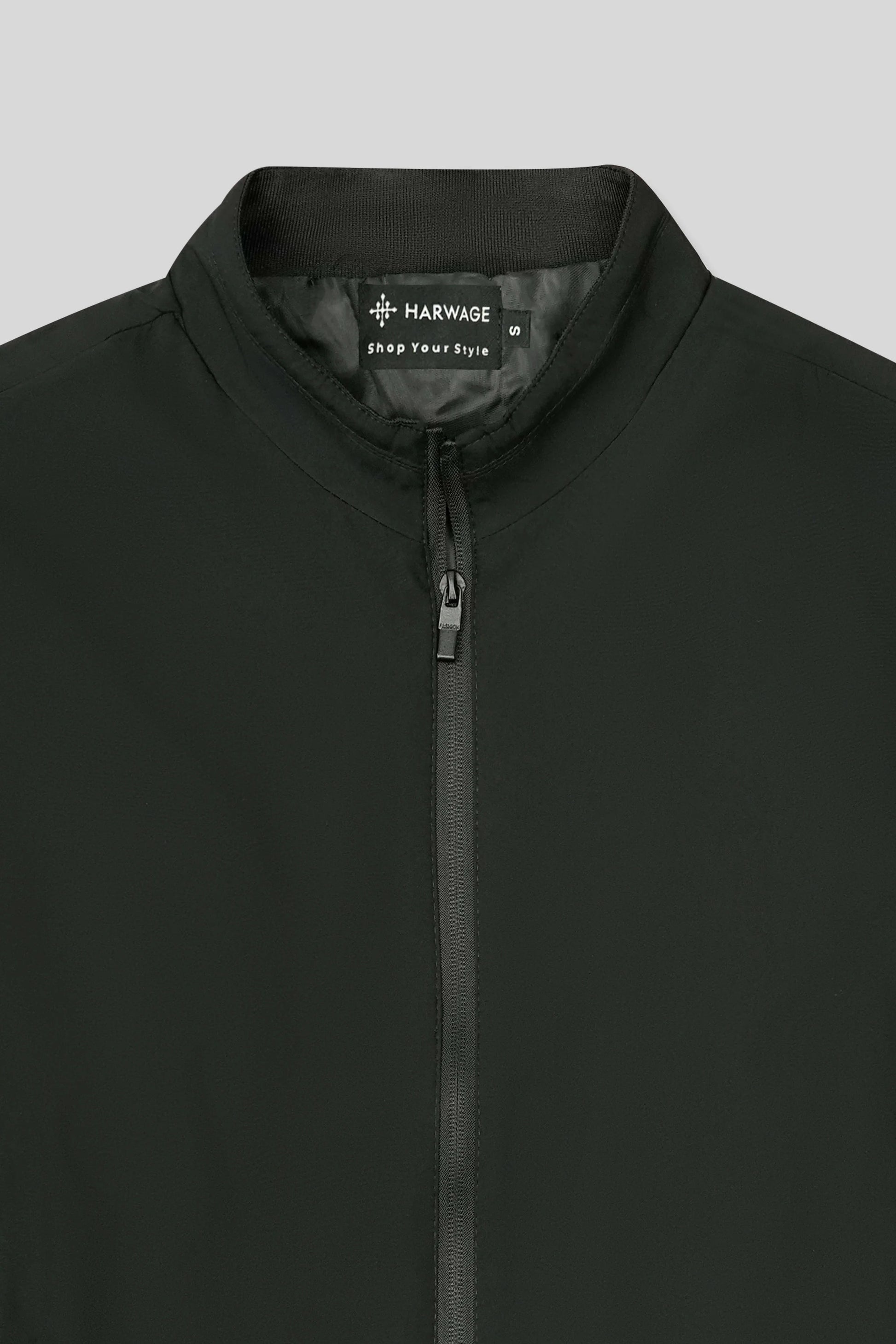 Black jacket with a visible brand logo on a gray background