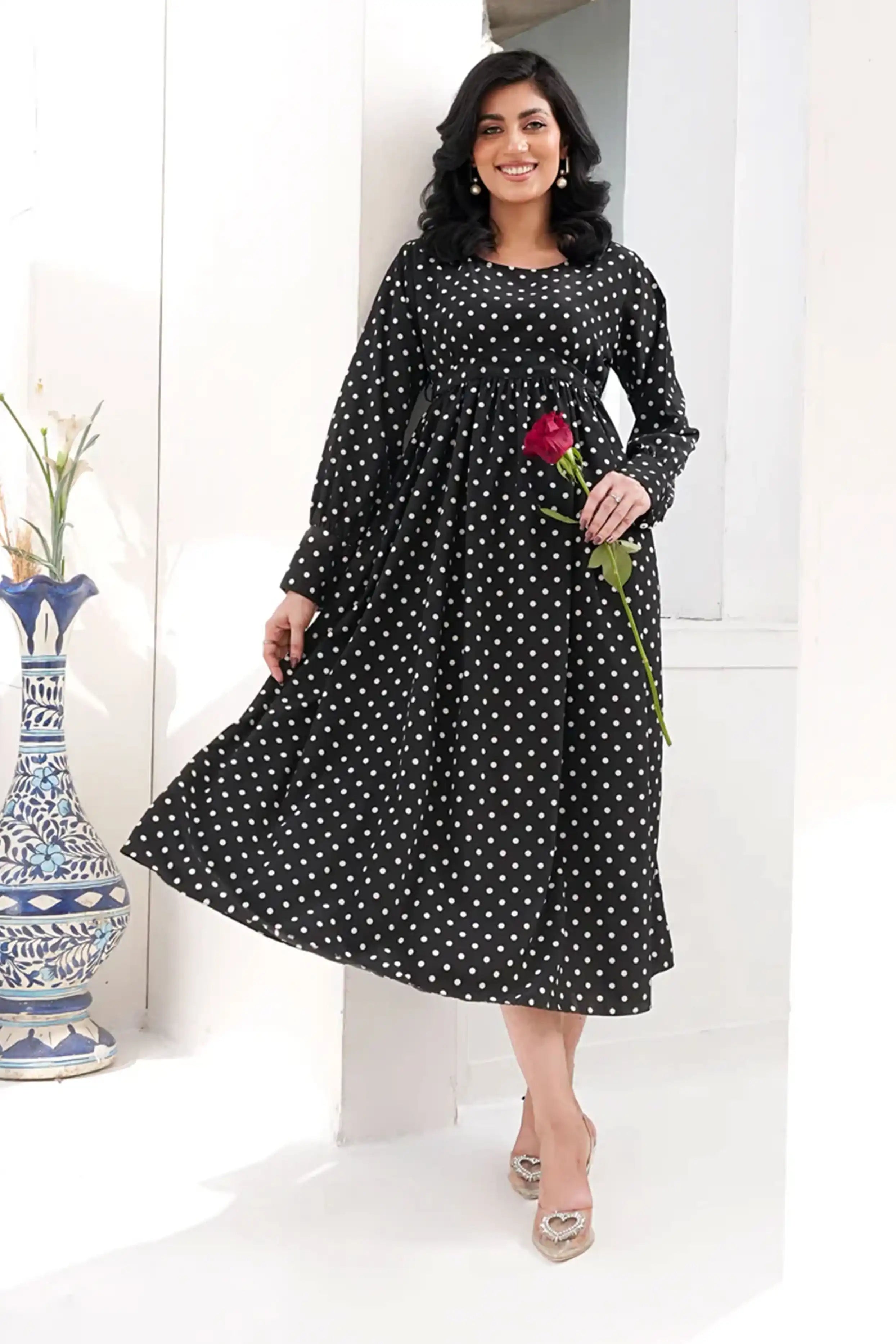 Woman wearing a black polka dot dress