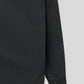 Black sweatshirt sleeve on a light gray background