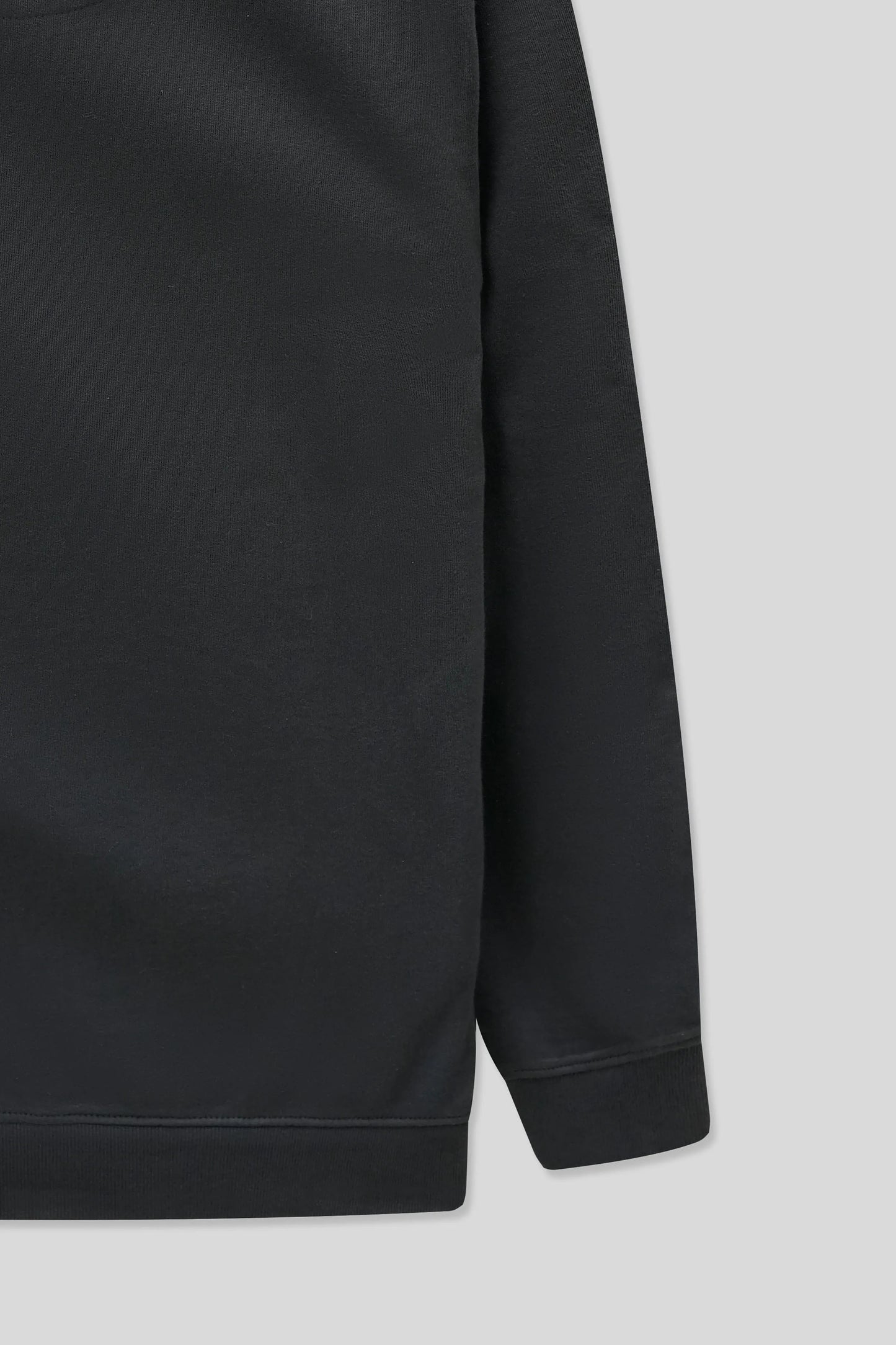 Black sweatshirt sleeve on a light gray background