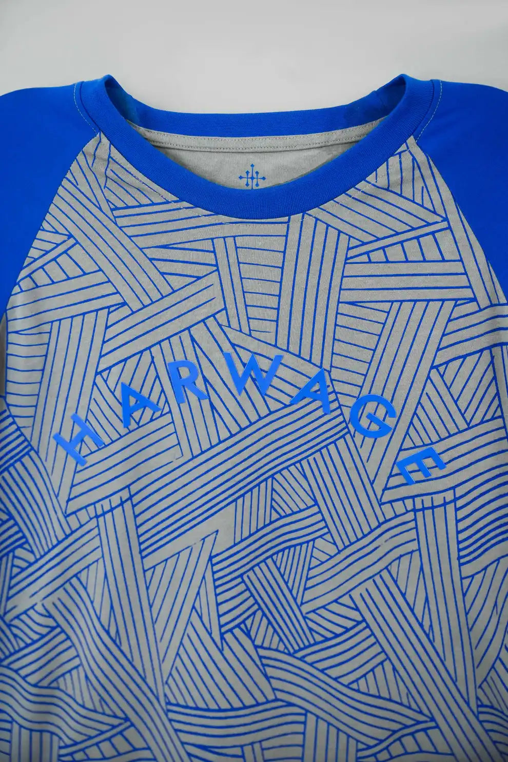 Blue and gray patterned shirt with 'Harwage' branding
