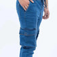 Blue cargo pants worn by a person on a white background