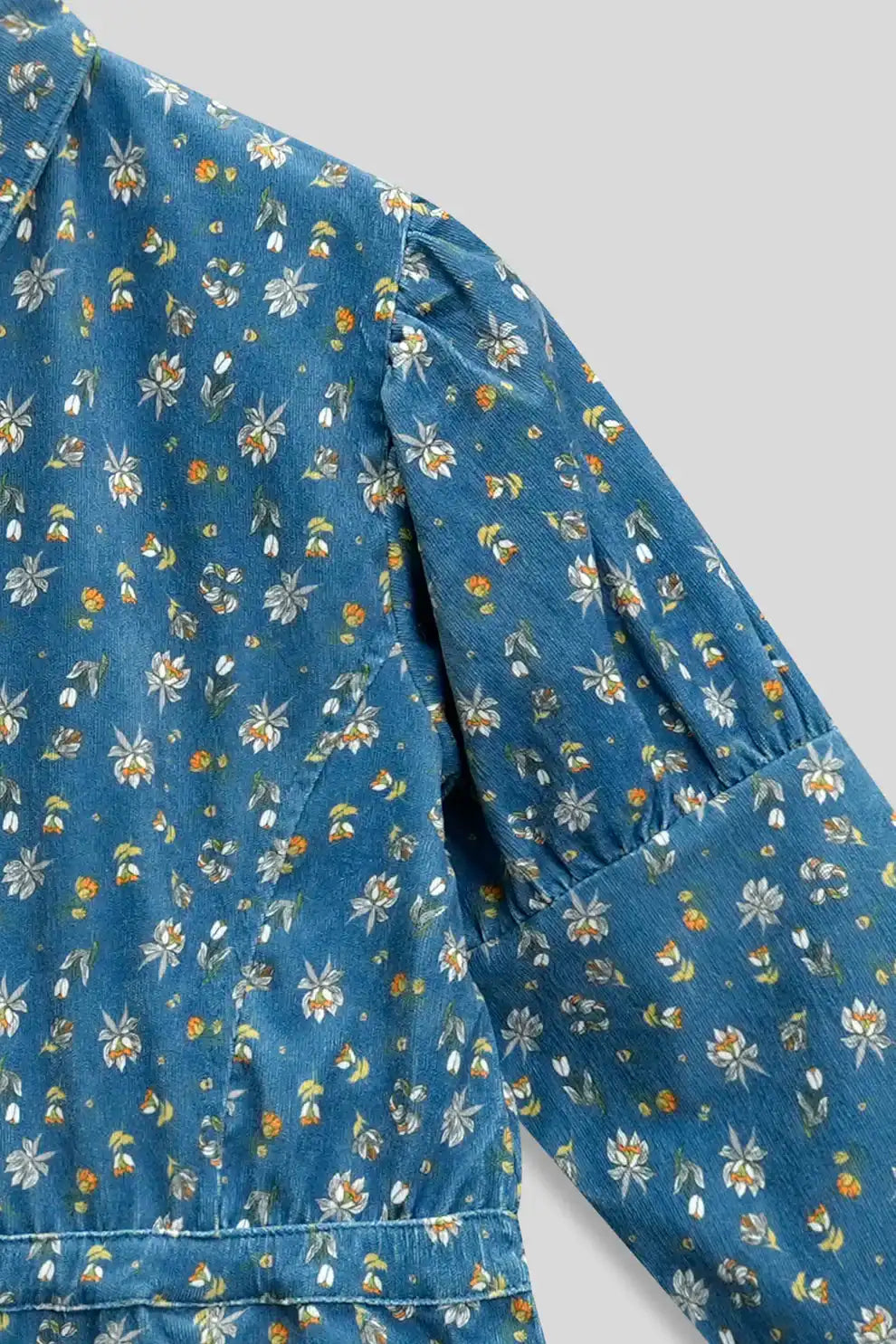 Blue floral-patterned shirt on a gray background