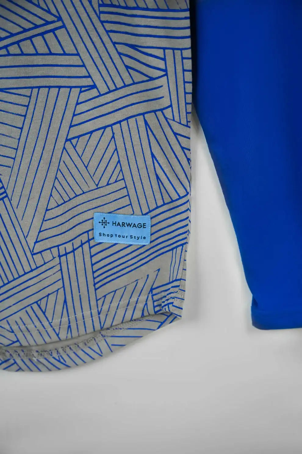 Blue geometric-patterned shirt with a visible brand label 