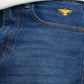 Close-up of blue jeans with a gold eagle logo on the pocket.