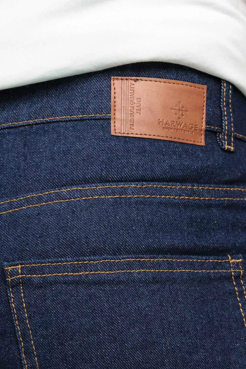 Close-up of blue jeans with a visible brand label on the pocket.