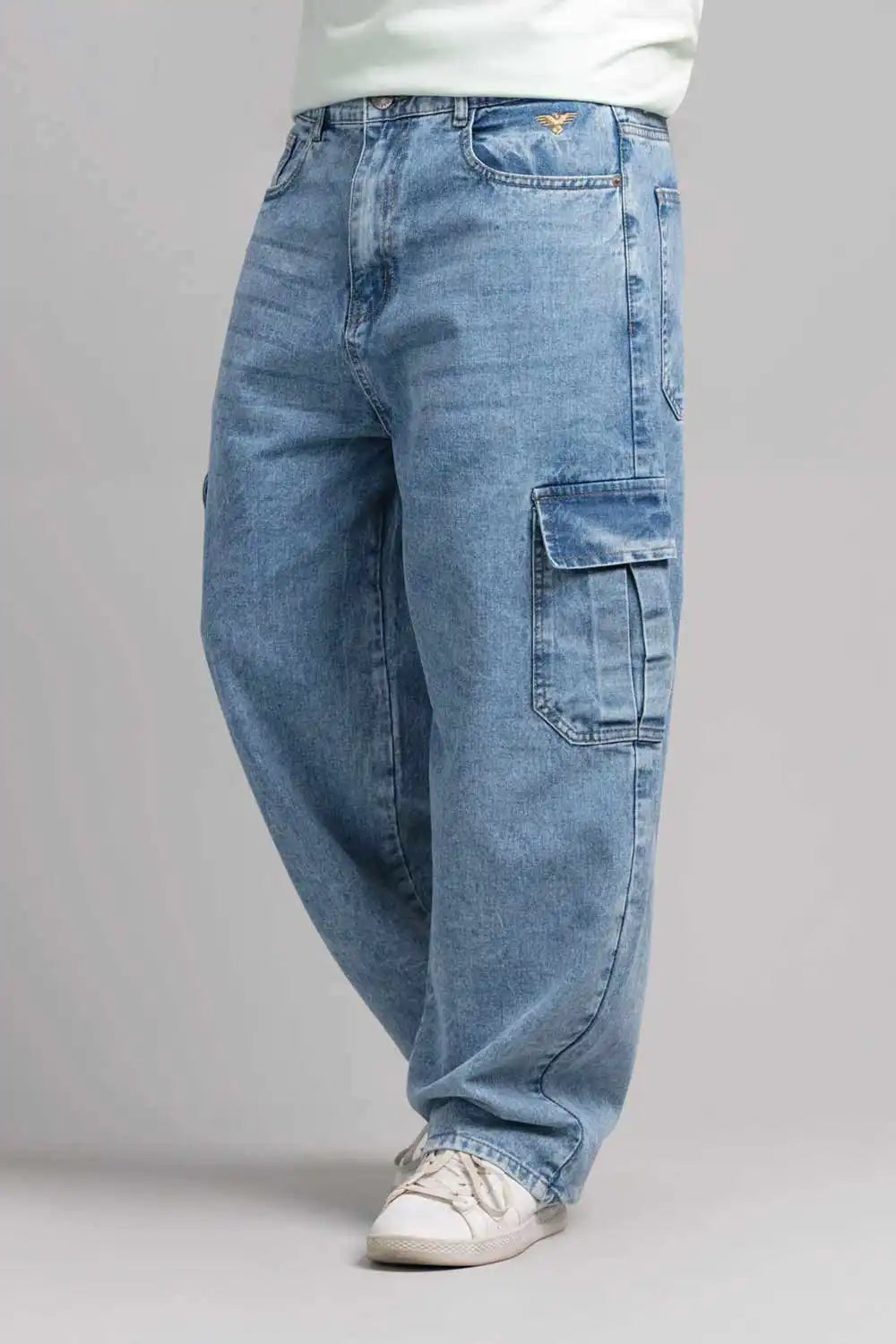 Blue jeans worn by a person on a gray background